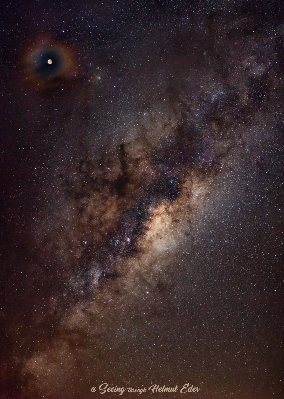 The picture shows total lunar eclipsed moon surrounded by a colorful atmospheric corona. 
Please see the explanation for more detailed information.