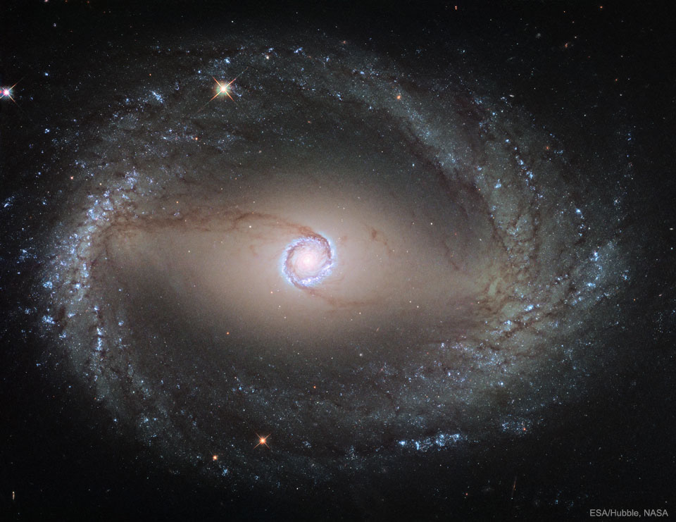 The featured image shows the spiral galaxy
NGC 1512 as taken by the Hubble Space Telescope. 
The galaxy shows two rings surrounding its center.
Please see the explanation for more detailed information.