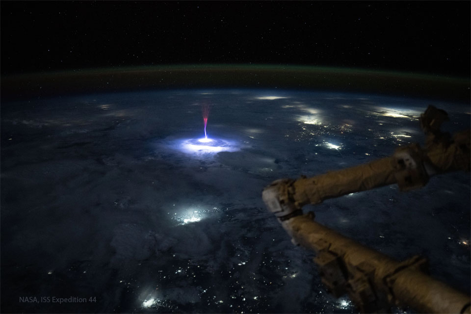 An image of Earth from space shows an unusual 
multi-colored jet in the middle of the frame.  
Please see the explanation for more detailed information.