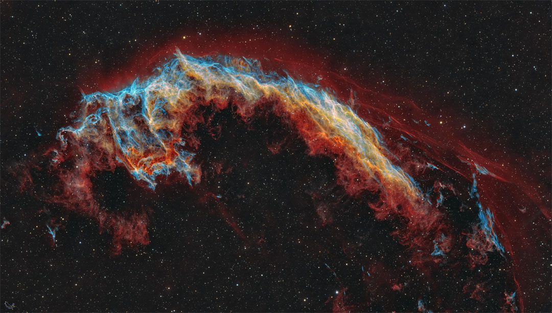 The featured image shows a starfield with a multi-
colored nebula in the center. The nebula is quite
filamentary but appears to some like a bat.
Please see the explanation for more detailed information.